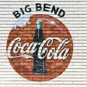 Ceramic tile mural of An old company sign appears on the wall of a Coca-Cola bottling plant outside Alpine, Texas